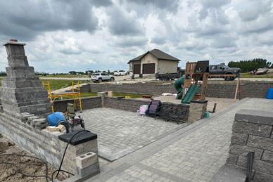Paver patio oasis with fireplace in progress
